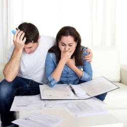 young couple worried at home in stress accounting bank documents