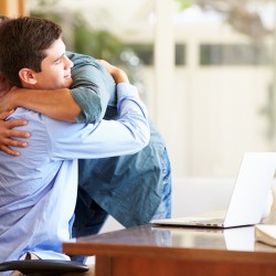 Father And Teenage Son Having A Hug