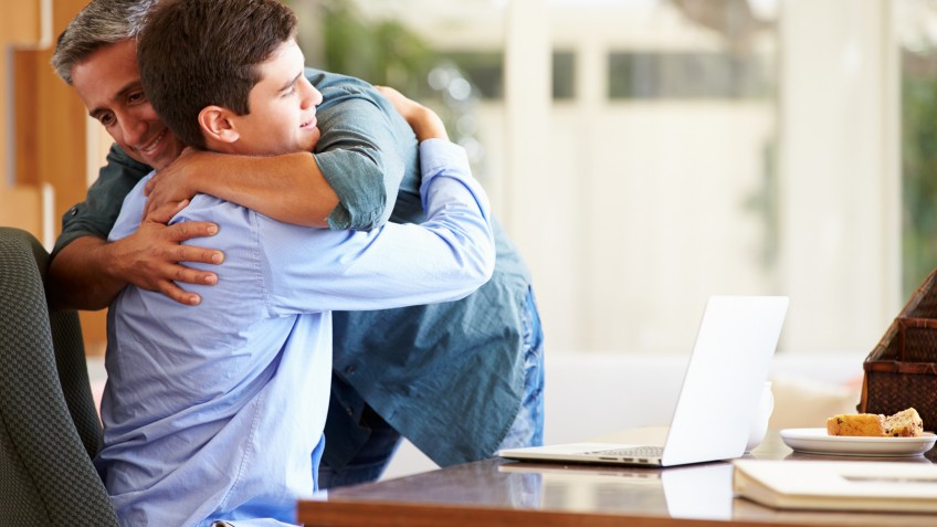 Father And Teenage Son Having A Hug