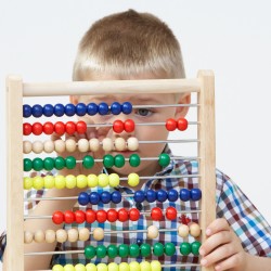 Studio Shot Of Boy Playing With Abacus