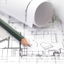 Architect rolls and plans construction project drawing