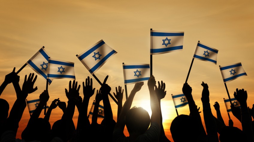 Silhouettes of People Waving the Flag of Israel