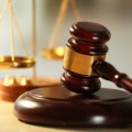 Wooden judges gavel on wooden table, close up