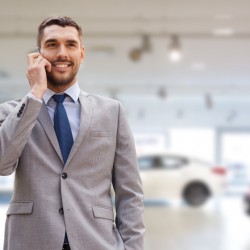 smiling businessman talking on smartphone