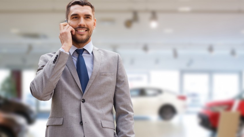 smiling businessman talking on smartphone