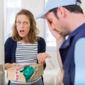 Young attractive woman angry against delivery man