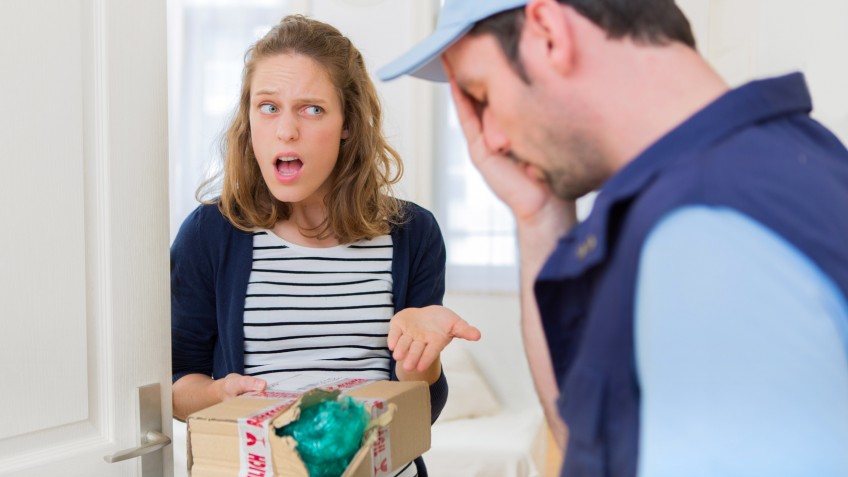 Young attractive woman angry against delivery man