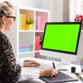 Designer using graphics tablet while working with computer