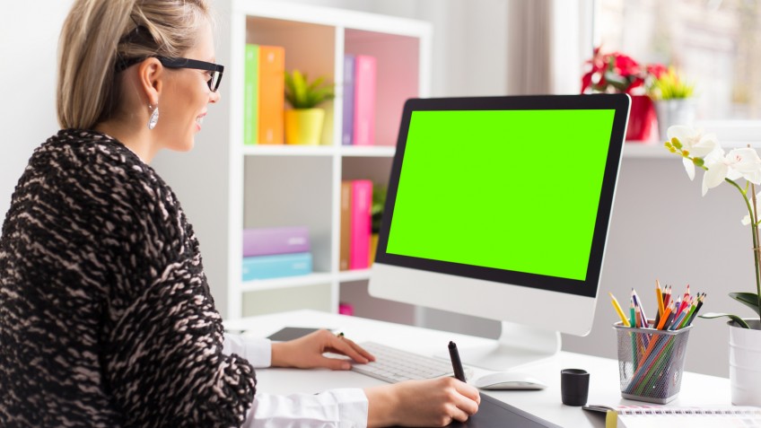 Designer using graphics tablet while working with computer