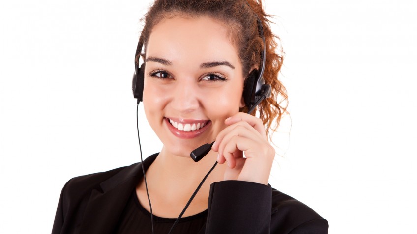 Portrait of a happy young call center employee smiling with a he