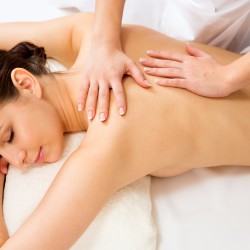 Masseur doing massage on the back of woman in the spa salon.