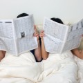 Couple reading newspapers