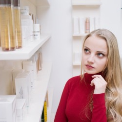 Young woman choosing cosmetics in a drugstore