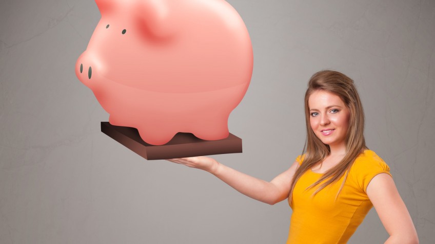 Young girl holding a huge savings piggy bank