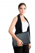 serious young woman standing with laptop. formal wear. isolated