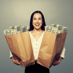 woman holding two paper bags with money