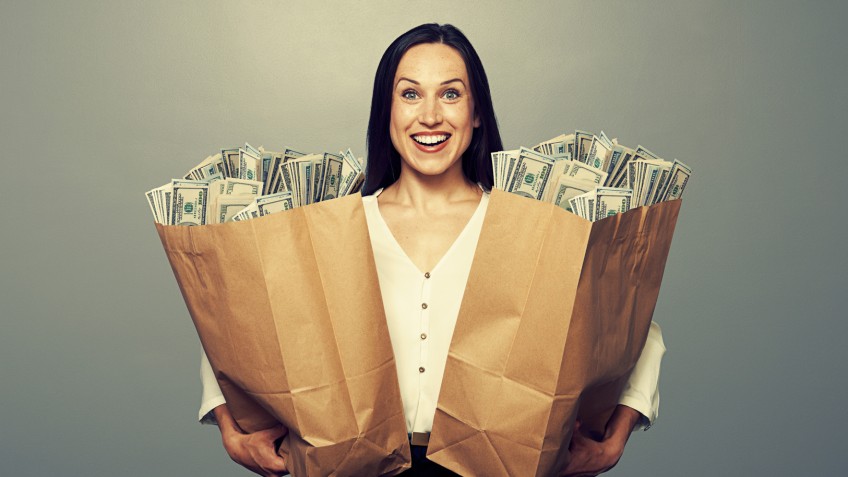 woman holding two paper bags with money
