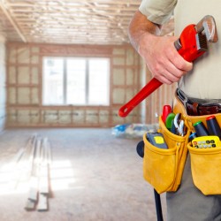 Builder handyman with construction tools.