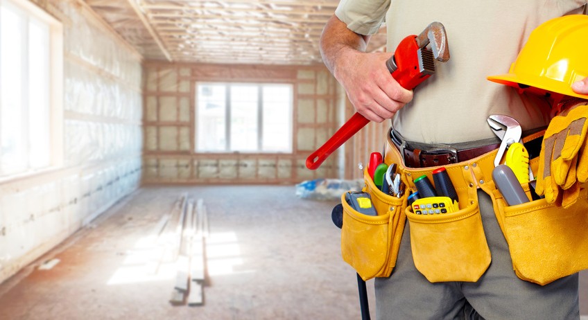 Builder handyman with construction tools.