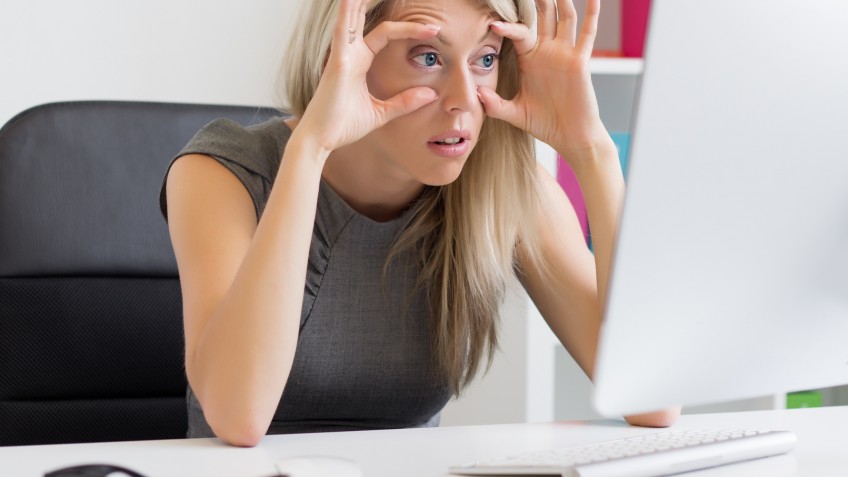 Tired and exhausted woman at work