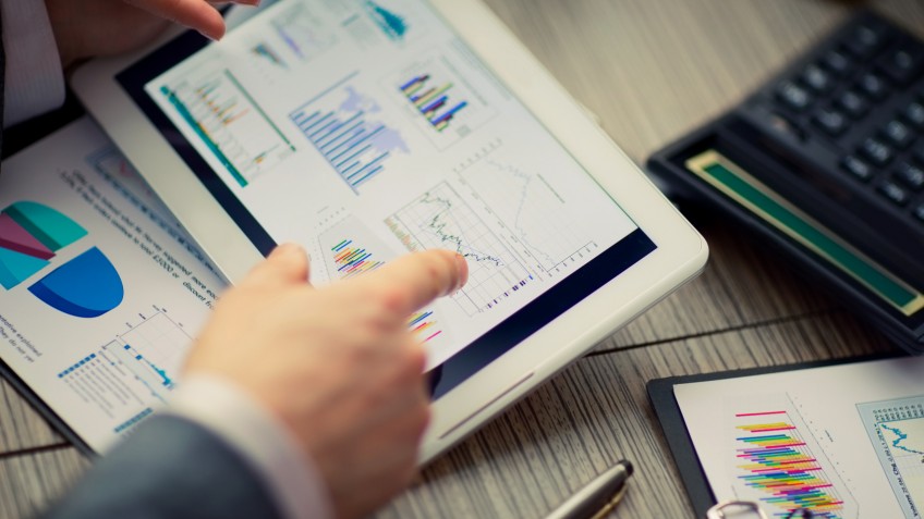 man on online Financial Assessment on a tablet .