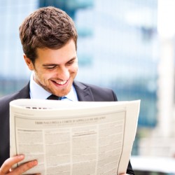 Business man reading a newspaper