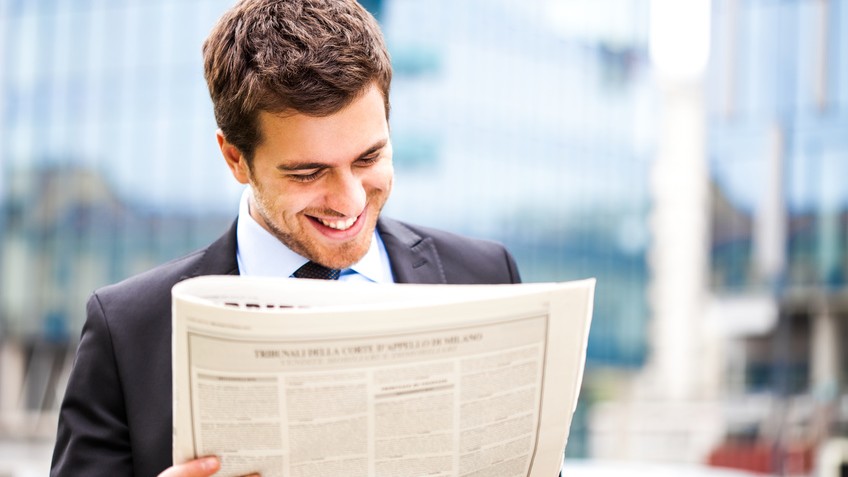 Business man reading a newspaper