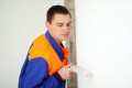 Young worker with level