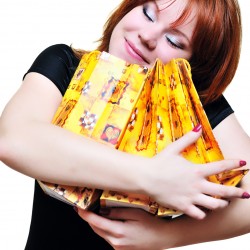 redheaded laughing girl after shopping over the white