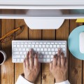 Businesswoman using pc computer on her office table