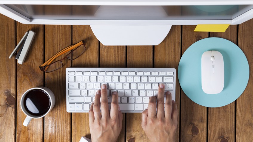 Businesswoman using pc computer on her office table