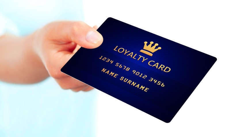 hand holding loyalty card isolated over white background