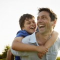 A father giving his son a piggyback.