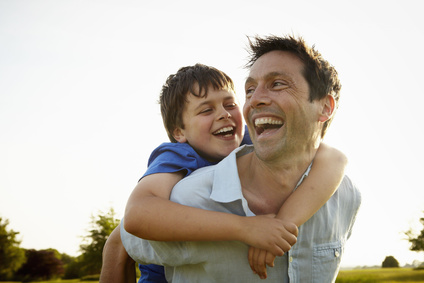 A father giving his son a piggyback.