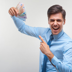 Businessman celebrating money income against white background