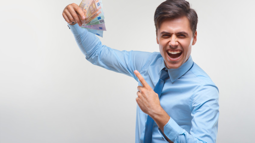 Businessman celebrating money income against white background