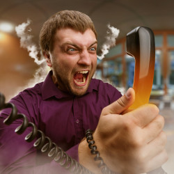 Angry bearded man screaming into the phone