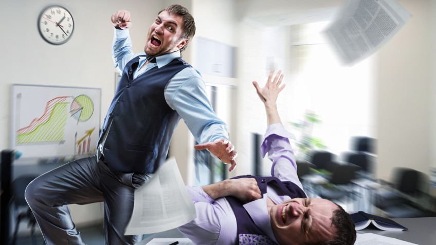 Two agressive businessmen fighting in the office