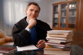 Attorney wearing classic gown in his office