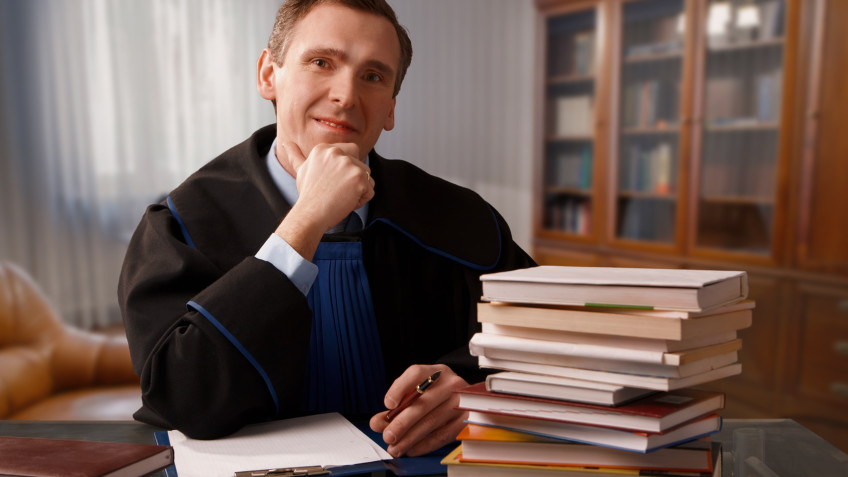 Attorney wearing classic gown in his office