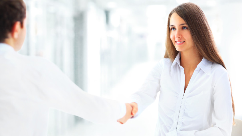 Cheerful businesspeople, or businesswoman and client handshaking