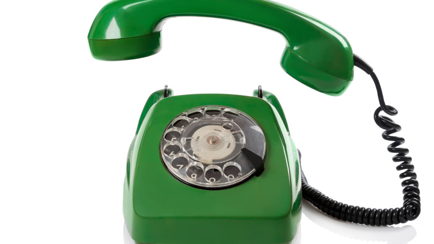 Green retro telephone on white background