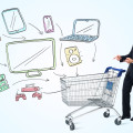 Businessman pushing a shopping cart drawn media devices coming out of it
