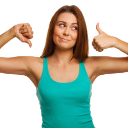 girl woman shows signs yes and no, hand fingers isolated on white background a T-shirt and jeans