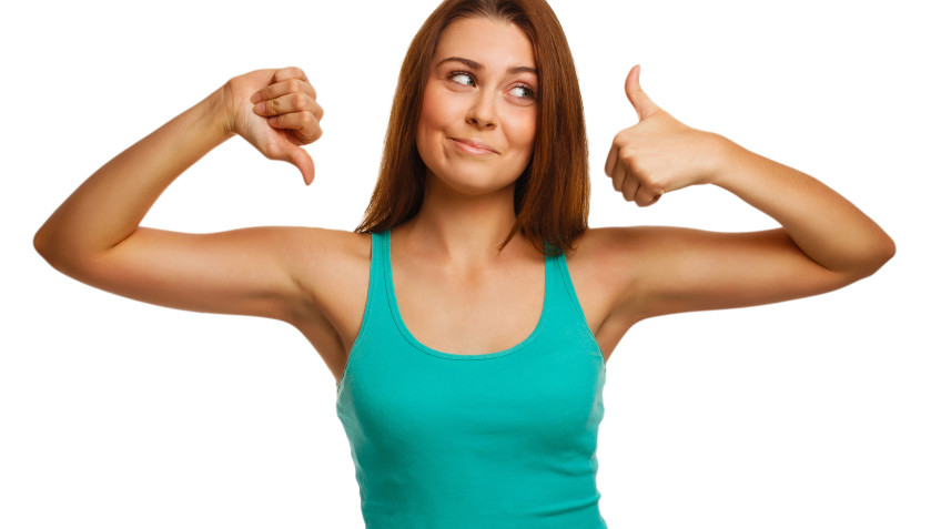 girl woman shows signs yes and no, hand fingers isolated on white background a T-shirt and jeans