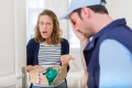 Young attractive woman angry against delivery man