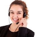 Portrait of a happy young call center employee smiling with a he