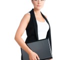 serious young woman standing with laptop. formal wear. isolated