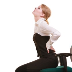 Businesswoman with backache back pain isolated