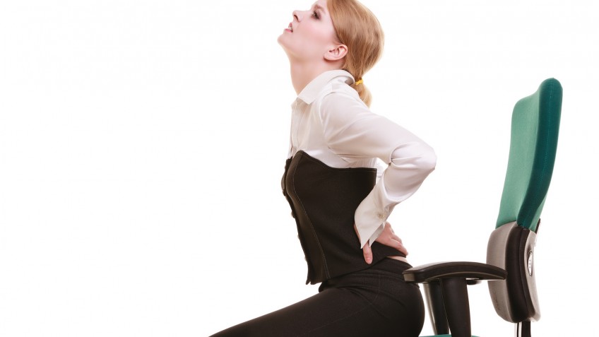 Businesswoman with backache back pain isolated
